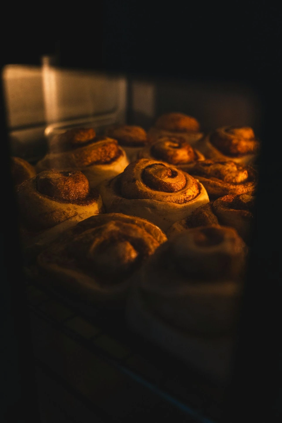A close up of a bunch of doughnuts baking in an oven